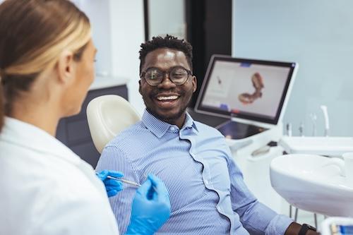 patient sitting in dentist exam chair smiling | sedation dentist high point nc