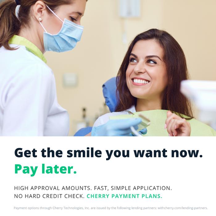 patient smiling in dentist exam chair | high point nc dentist