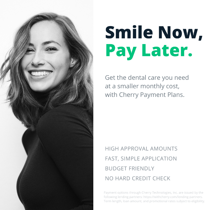 woman in black sweater smiling | cosmetic dentistry high point nc