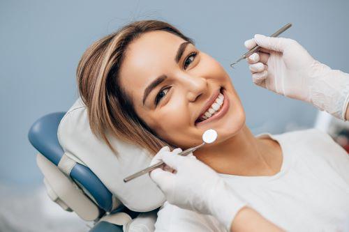 patient sitting in dentist exam chair smiling | dental office high point nc