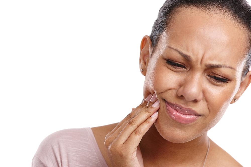 woman in pain holding jaw | emergency dentist high point nc