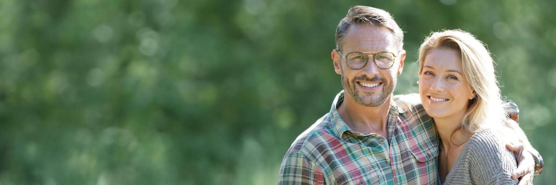 man in plaid shirt smiling with woman | high point dentist